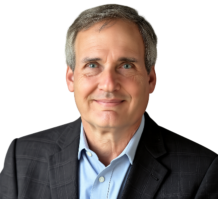 Headshot of Warren B. Powell — silver-grey hair, navy blazer, light blue shirt, smiling, photographed against a plain background